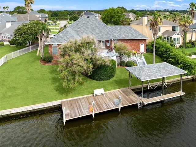 dock area with a water view and a yard