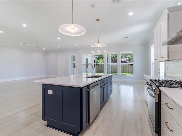 kitchen with stainless steel appliances, white cabinetry, hanging light fixtures, and sink