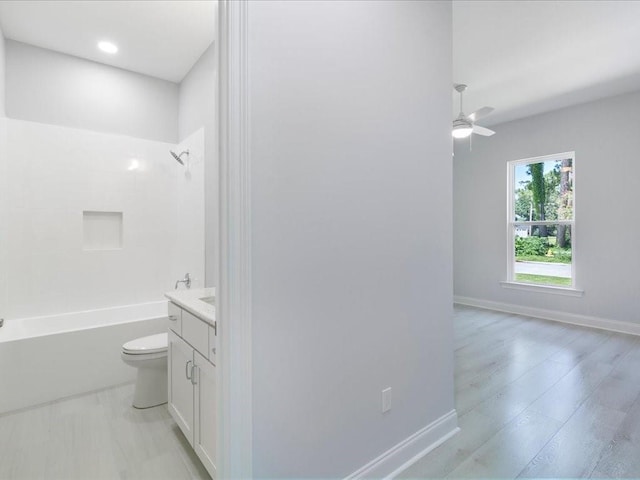 full bathroom featuring vanity, ceiling fan, toilet, and shower / bathtub combination