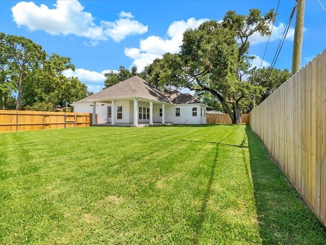 back of house with a yard