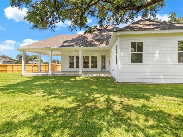 back of house featuring a yard and a patio