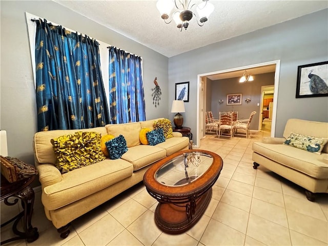 tiled living room featuring a notable chandelier and a textured ceiling