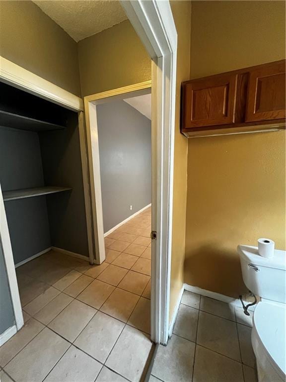 bathroom featuring toilet and tile patterned floors