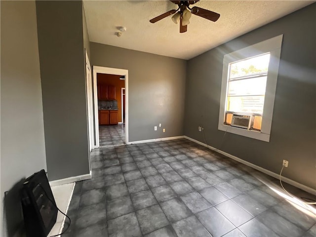 unfurnished room with a textured ceiling, cooling unit, and ceiling fan