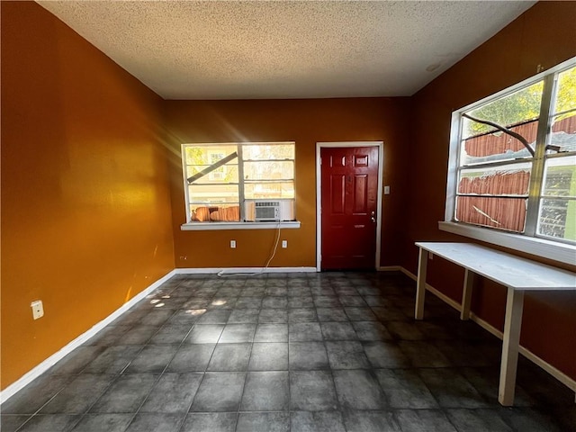 foyer with a textured ceiling and cooling unit