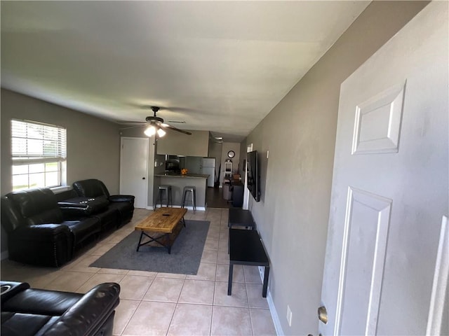 tiled living room featuring ceiling fan