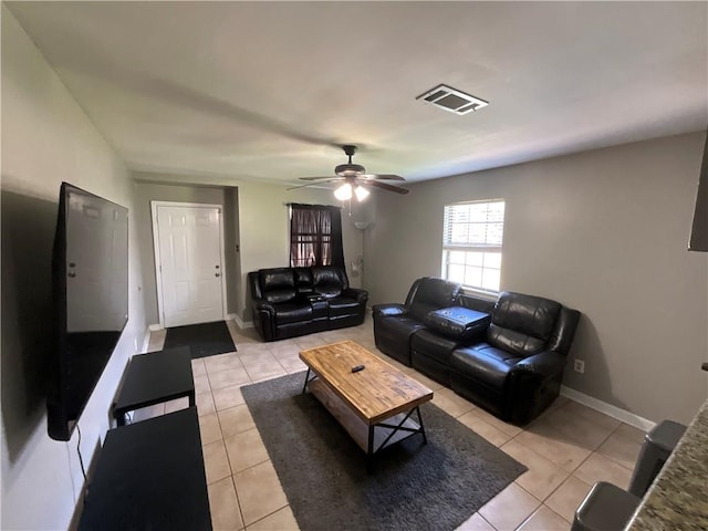 tiled living room with ceiling fan