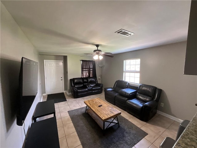 tiled living room with ceiling fan