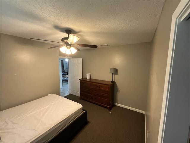 bedroom with carpet flooring, ceiling fan, and a textured ceiling