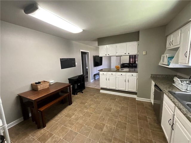 kitchen with sink, white cabinets, tile flooring, and dishwasher