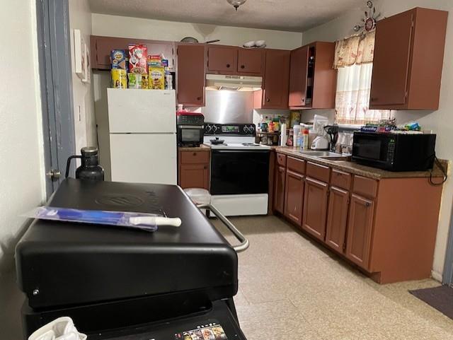 kitchen featuring sink, white appliances, and light tile patterned floors