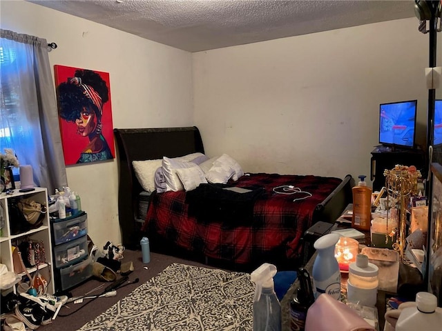 bedroom with carpet and a textured ceiling