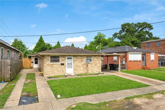 view of front facade with a carport and a front lawn