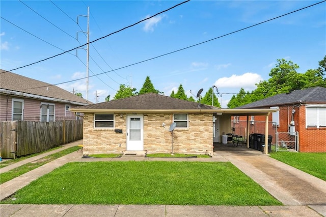 view of front of property with a front yard and a carport