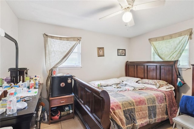 bedroom with ceiling fan and light tile patterned floors