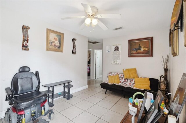 sitting room with ceiling fan and light tile patterned flooring