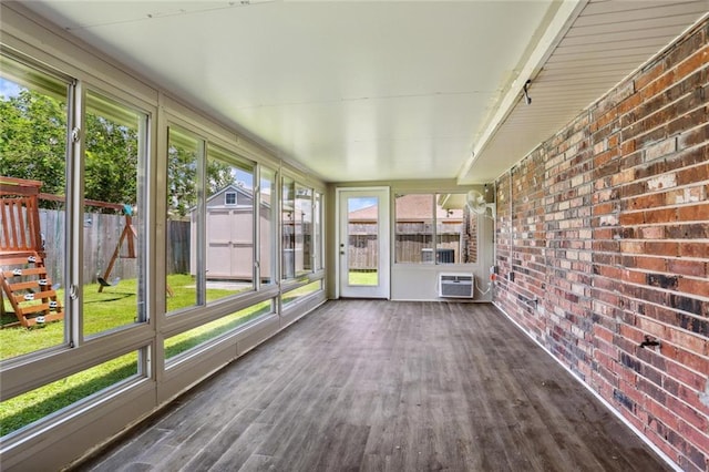 unfurnished sunroom featuring a wall mounted AC