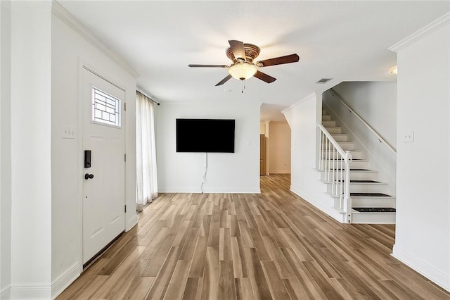 unfurnished living room with ornamental molding, ceiling fan, and light hardwood / wood-style floors