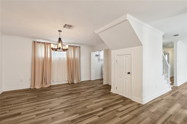 bonus room featuring a chandelier and hardwood / wood-style floors