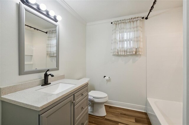 full bathroom featuring crown molding, toilet, bathing tub / shower combination, vanity, and wood-type flooring