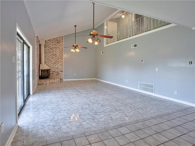 unfurnished living room with ceiling fan, light tile patterned floors, a wood stove, and high vaulted ceiling