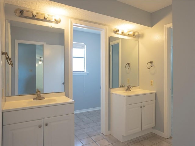 bathroom with tile patterned flooring and vanity