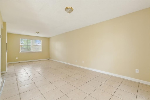 spare room featuring light tile patterned floors