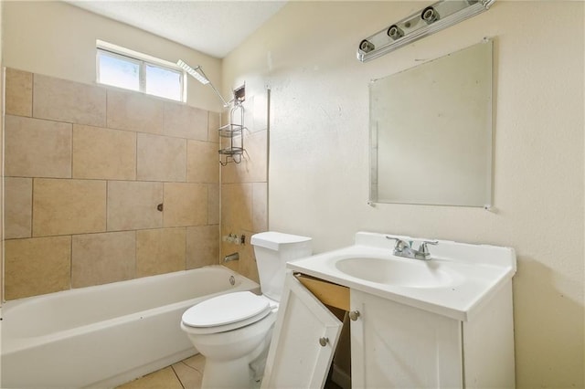 full bathroom with tile patterned flooring, vanity, tiled shower / bath combo, and toilet