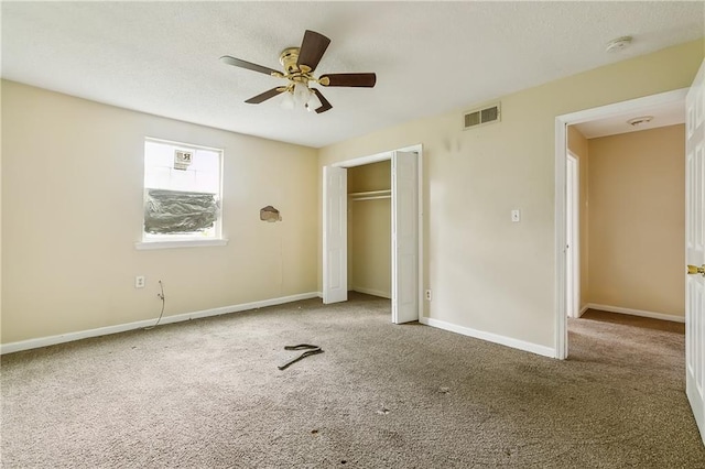 unfurnished bedroom with carpet, ceiling fan, and a closet