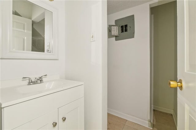 bathroom featuring tile patterned floors, electric panel, vanity, and a textured ceiling