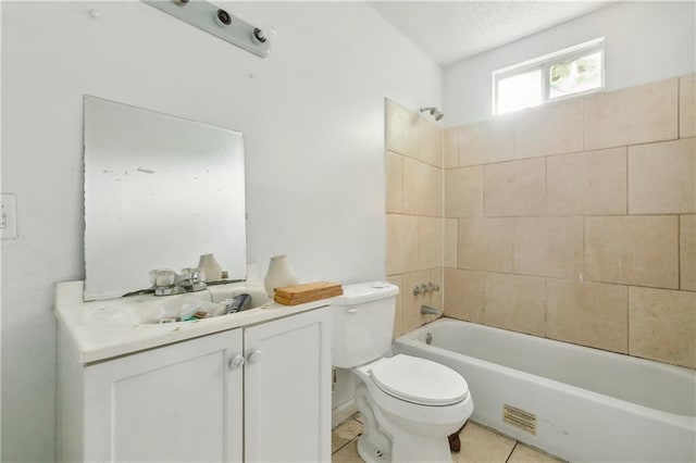 full bathroom featuring tiled shower / bath, vanity, toilet, and tile patterned floors