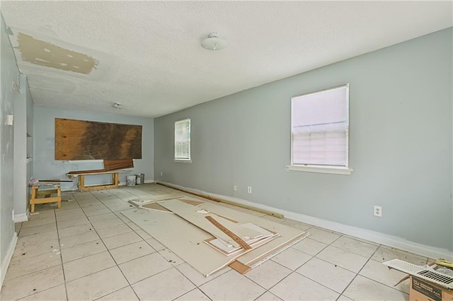 spare room with a textured ceiling