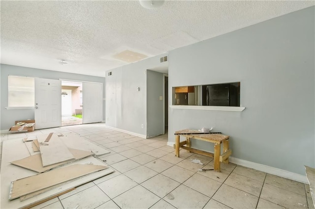 spare room with a textured ceiling