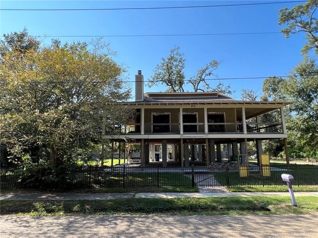 back of house with a lawn