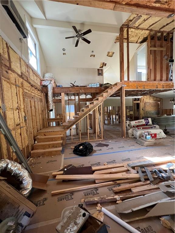 miscellaneous room with beamed ceiling, ceiling fan, and high vaulted ceiling