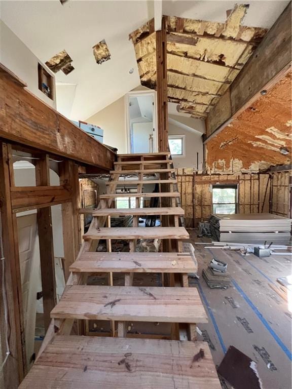 staircase with high vaulted ceiling