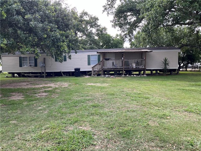 rear view of house with a yard and a deck