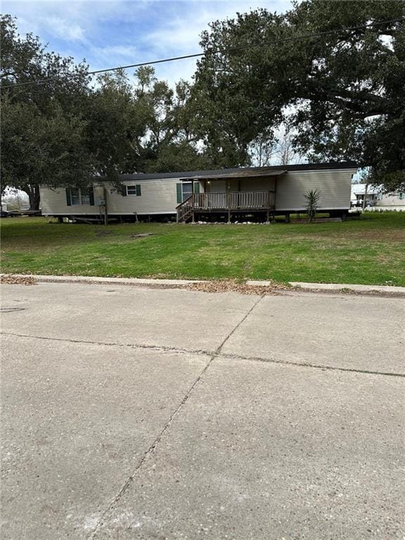 view of front of house featuring a deck and a front yard