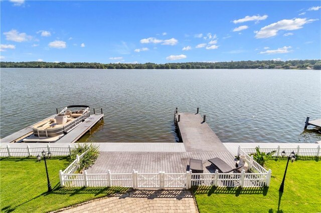 view of dock with a water view and a lawn