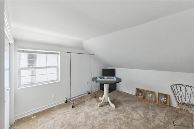 bonus room with lofted ceiling and light colored carpet