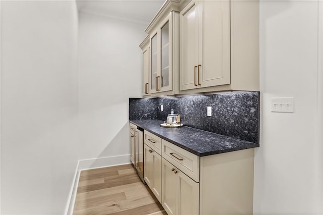 kitchen with backsplash, light hardwood / wood-style floors, and cream cabinetry