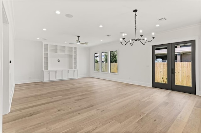 unfurnished living room featuring french doors, ornamental molding, ceiling fan with notable chandelier, built in features, and light hardwood / wood-style flooring