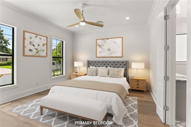 bedroom featuring ceiling fan, crown molding, and light wood-type flooring