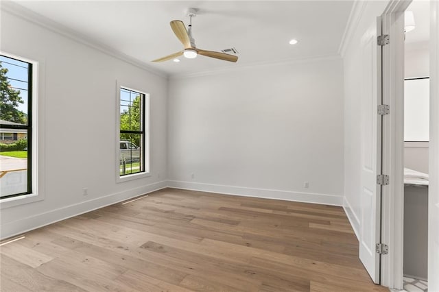 empty room with crown molding, ceiling fan, and light hardwood / wood-style floors