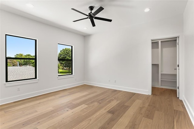 unfurnished bedroom featuring ceiling fan, light hardwood / wood-style flooring, and a closet