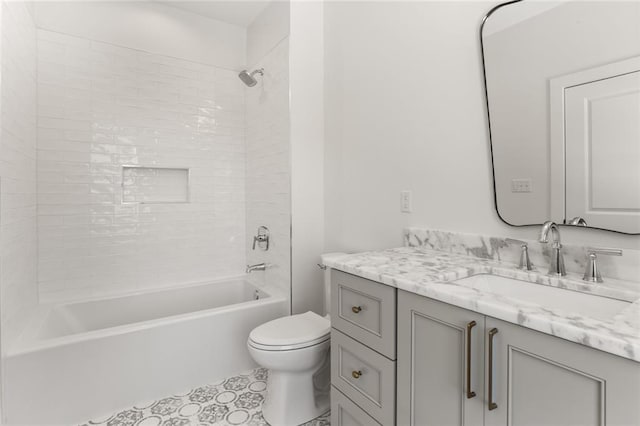 full bathroom featuring vanity, toilet, and tiled shower / bath