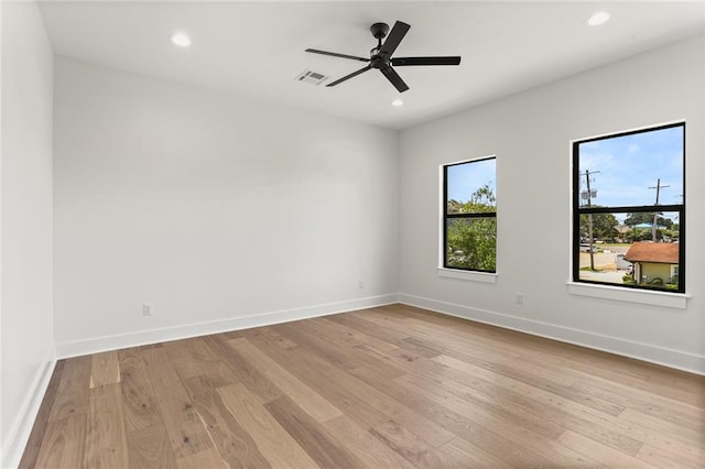 unfurnished room featuring light wood-type flooring and ceiling fan