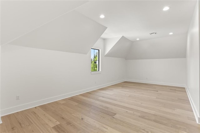 bonus room featuring light hardwood / wood-style flooring and lofted ceiling