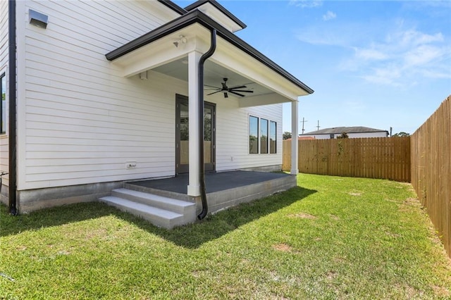 exterior space with a yard and ceiling fan