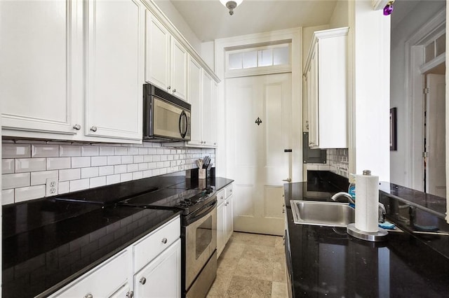 kitchen with white cabinetry, stainless steel electric range oven, sink, and backsplash